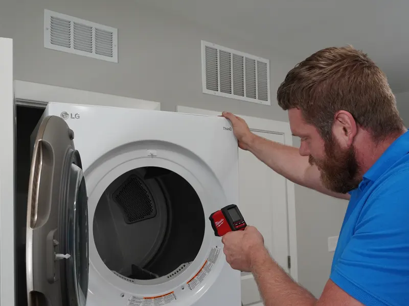 Dryer control panel tested with a multimeter during a no-heat repair call