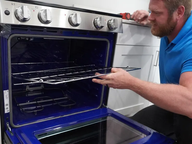 Range cooktop and control knobs tested during a burner repair visit