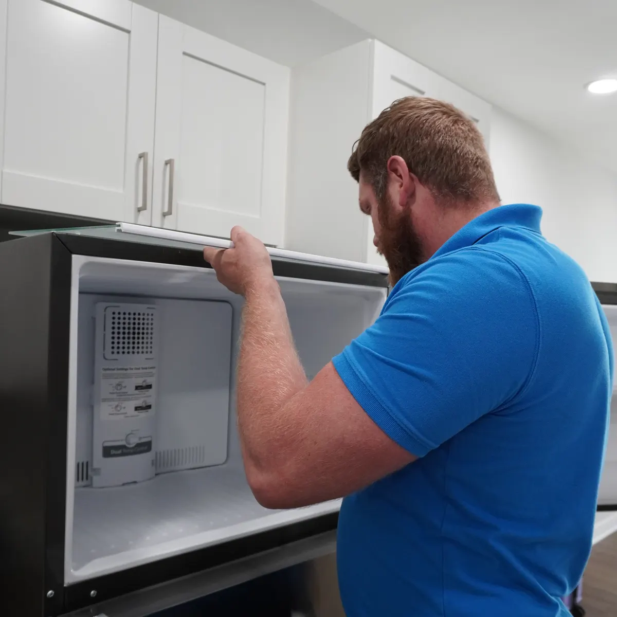 Refrigerator freezer compartment being serviced in an Indianapolis-area kitchen