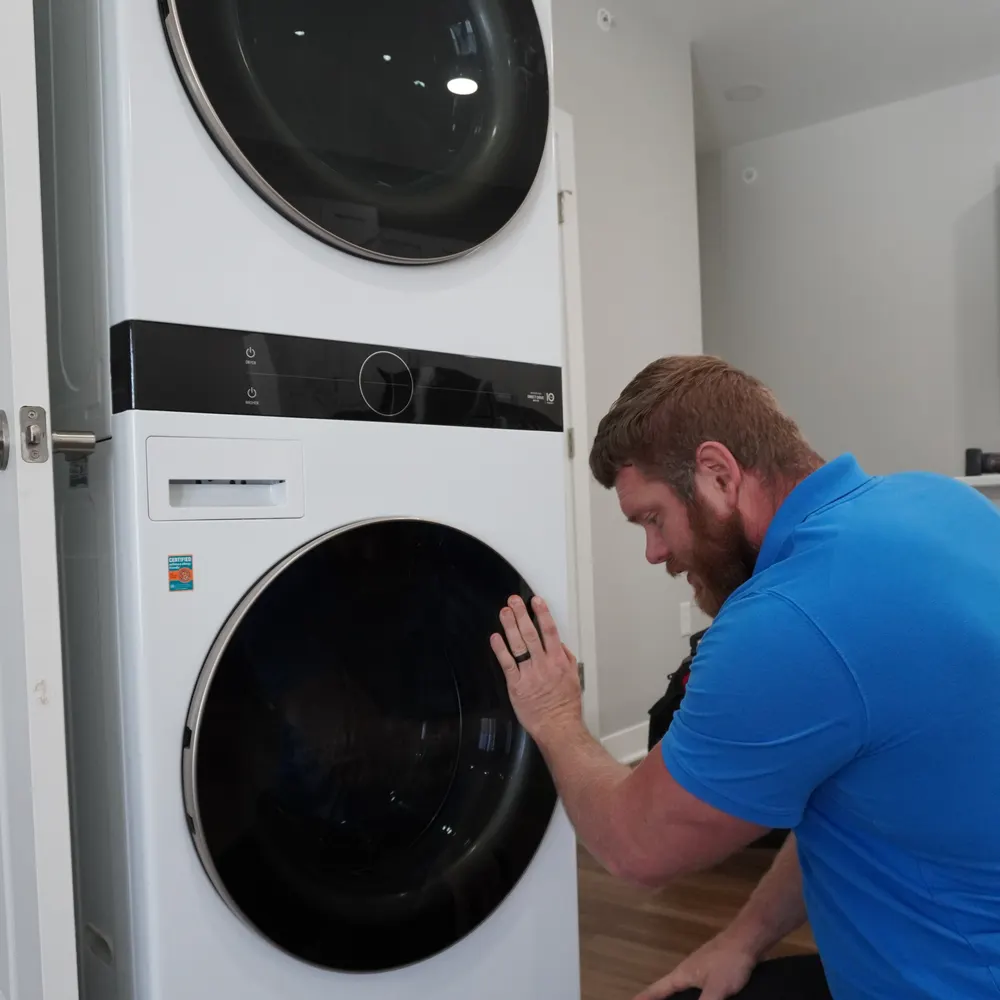 Front-load washer serviced with the drum door open in an Indianapolis-area laundry room